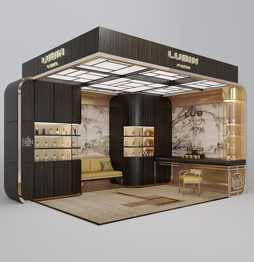 Vue en perspective d'un corner de vente Lubin : structure de bois sombre et de laiton, enseignes LUBIN PARIS, etageres eclairees garnies de flacons, banquette verte, tabouret et tapis a motifs.