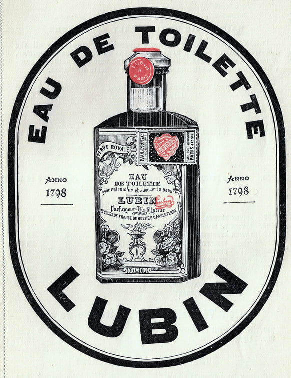 Étiquette gravée de forme ovale : un flacon d'eau de toilette Lubin au bouchon de cire rouge, entouré des mots EAU DE TOILETTE en haut et LUBIN en bas, avec la mention Anno 1798 de part et d'autre.