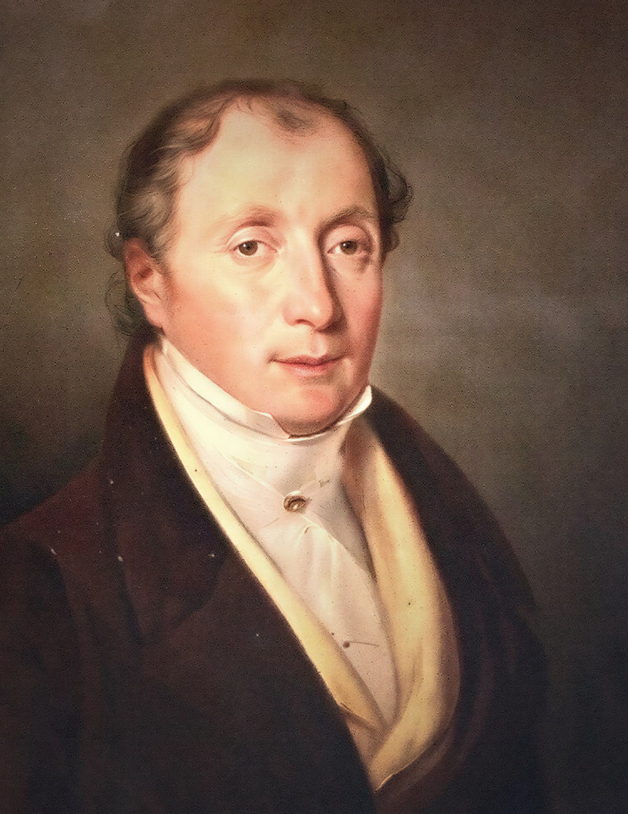 Portrait peint de Pierre-François Lubin, le fondateur : un homme aux cheveux gris, en habit sombre, haute cravate blanche et gilet jaune pâle, sur un fond brun.
